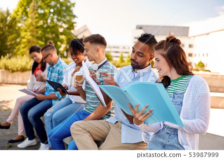 group of happy students with notebooks and drinks group of happy students with notebooks and drinks 53987999