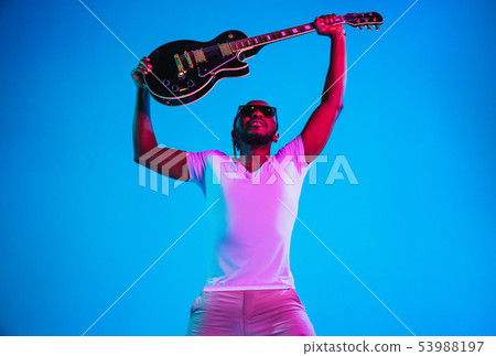 Young african-american jazz musician playing the guitar Young african-american jazz musician playing the guitar 53988197