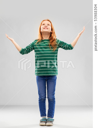 happy grateful red haired girl looking up above 53988304