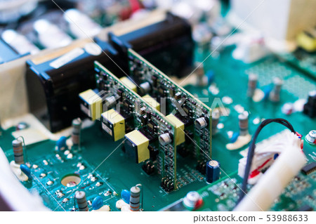 Resistors, capacitors and other electronic components of micro chip inside the computer close up Resistors, capacitors and other electronic components of micro chip inside the computer close up 53988633