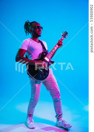 Young african-american jazz musician playing the guitar 53988902