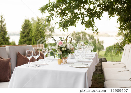Wedding table setting decorated with fresh flowers 53989407