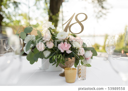 Wedding table setting decorated with fresh flowers Wedding table setting decorated with fresh flowers 53989558