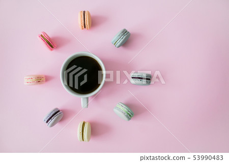 Macaroons around coffee cup on a pink background. Flatlay. 53990483