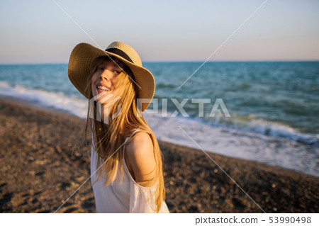 Young happy girl relaxing at the beach. Young happy girl relaxing at the beach. 53990498