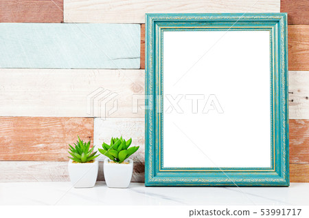 Blank vintage photo frame on wooden wall with Blank vintage photo frame on wooden wall with 53991717