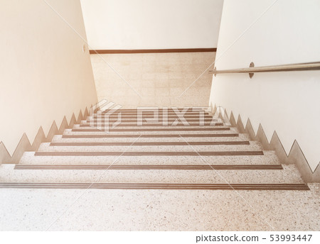 stairs walkway down terrazzo flooring in interior 53993447