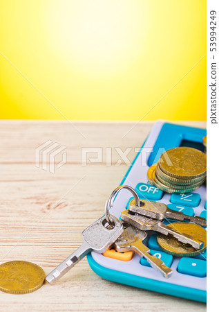 stacking coin with bunch of key on calculator stacking coin with bunch of key on calculator 53994249
