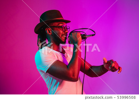 Young african-american jazz musician singing a song Young african-american jazz musician singing a song 53996508