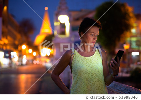 Mature beautiful Scandinavian tourist woman exploring Nakhon Pat Mature beautiful Scandinavian tourist woman exploring Nakhon Pat 53998346
