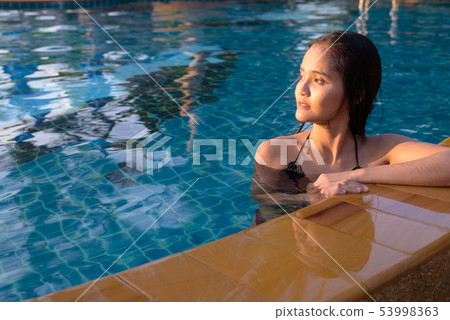 Young beautiful Asian tourist woman enjoying vacation Young beautiful Asian tourist woman enjoying vacation 53998363