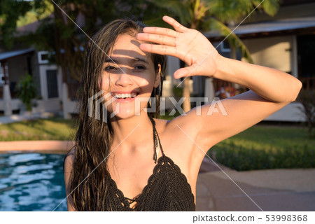 Young beautiful Asian tourist woman enjoying vacation 53998368