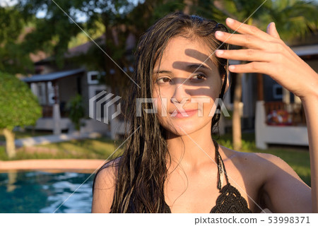 Young beautiful Asian tourist woman enjoying vacation Young beautiful Asian tourist woman enjoying vacation 53998371