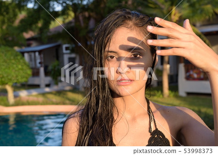 Young beautiful Asian tourist woman enjoying vacation 53998373