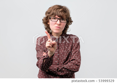 Woman showing index finger stopping forbidding you 53999329