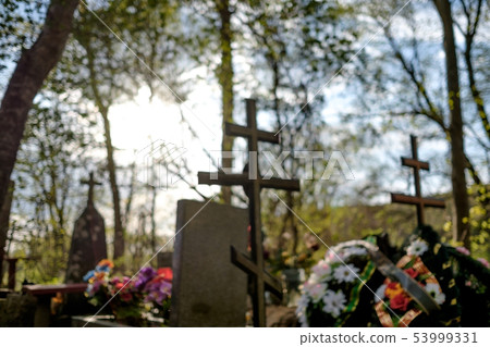Blurred grave cross on the Orthodox Christian cemetery Blurred grave cross on the Orthodox Christian cemetery 53999331