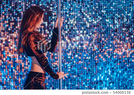 Sexy woman with long hair standing near pylon in night club. attractive girl Sexy woman with long hair standing near pylon in night club. attractive girl 54000136
