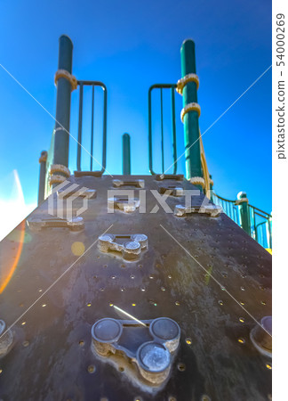 Lens flare on a rock climbing unit on playground 54000269