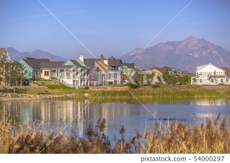Lakefront homes along Oquirrh Lake on a sunny day 54000297