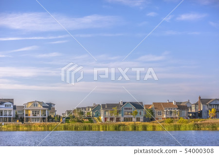 Idyllic view of Oquirrh Lake with homes and sky 54000308