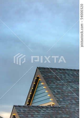 House with Christmas lights on the edge of roof House with Christmas lights on the edge of roof 54000320