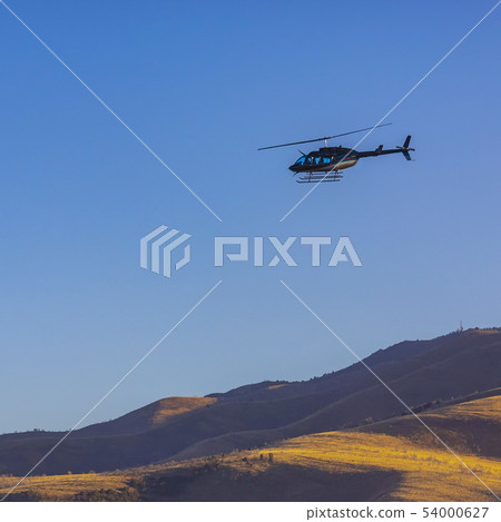 Helicopter hovers over canyon in Utah Valley Helicopter hovers over canyon in Utah Valley 54000627