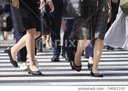 Feet of a woman crossing a pedestrian crossing Feet of a woman crossing a pedestrian crossing 54001193