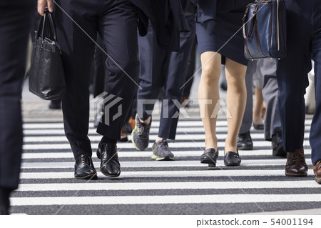 Feet of a woman crossing a pedestrian crossing Feet of a woman crossing a pedestrian crossing 54001194