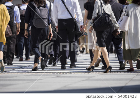 Feet of a woman crossing a pedestrian crossing 54001428