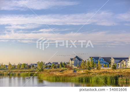 Flock of birds in the cloudy sky over Oquirrh Lake 54001606