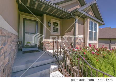 Facade of home with yard stairs and font porch 54001620
