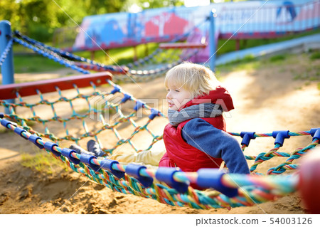 Cute little blond caucasian boy having fun on Cute little blond caucasian boy having fun on 54003126