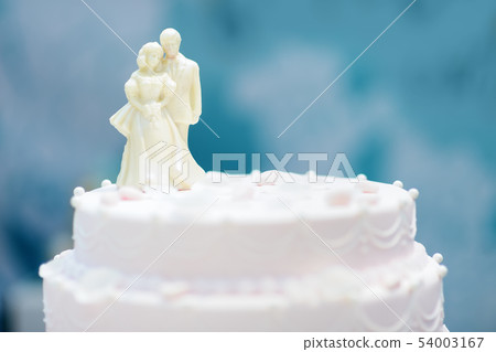 Beautiful wedding cake with figurines from white Beautiful wedding cake with figurines from white 54003167