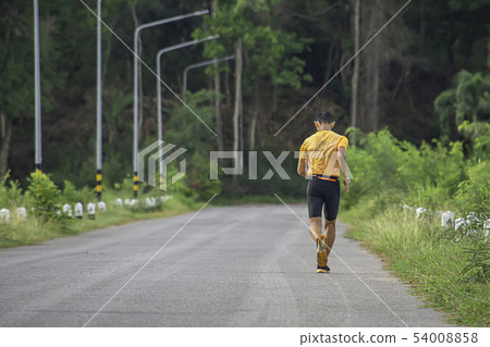 Men are running on the road Background light poles Men are running on the road Background light poles 54008858
