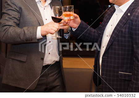 Two men drinking Two men drinking 54010332