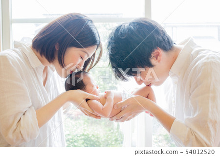 Daddy and Mom kissing a newborn baby Daddy and Mom kissing a newborn baby 54012520