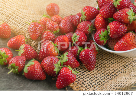 Stack of strawberries on sack cloth 54012967