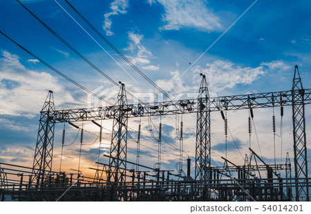 Sunset behind substation towers with blue sky Sunset behind substation towers with blue sky 54014201