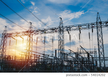Sunset behind substation towers with blue sky Sunset behind substation towers with blue sky 54014202