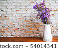 Purple bouquet in the white jar on wooden table 54014341
