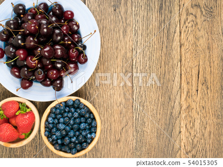 Fresh Summer Berries on Rustic Wooden Background 54015305