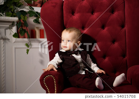 One-year-old cheerful baby boy plays at home. One-year-old cheerful baby boy plays at home. 54015708