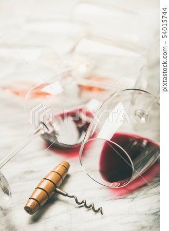 Red and rose wine in glasses over grey marble 54015744