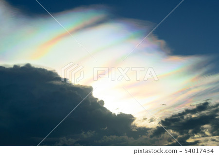 Rare fire rainbow in dark stormy clouds. 54017434