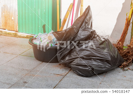 plastic trash bag. Pile black garbage On floor 54018147