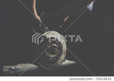 Disc brake and asbestos brake pads at car garage Disc brake and asbestos brake pads at car garage 54018638