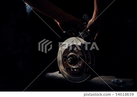 Disc brake and asbestos brake pads at car garage Disc brake and asbestos brake pads at car garage 54018639