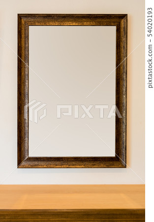 The blank wooden picture frame on the wall The blank wooden picture frame on the wall 54020193