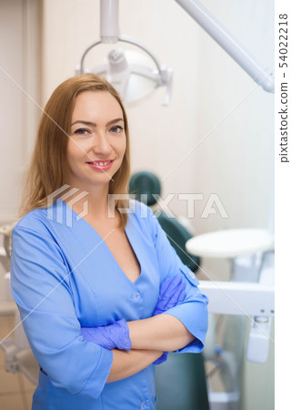 Dentist examining a patient's teeth in the dentist Dentist examining a patient's teeth in the dentist 54022218