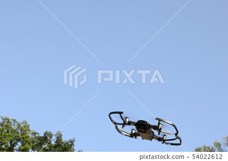 Drone with photocamera take off from land and 54022612